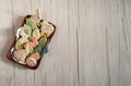 Basket with delicious homemade cookies in the form of Easter rabbits, eggs, birds and lambs on a wooden background.