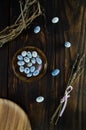 Easter composition. Blue eggs on wooden plate with dried lavender on dark vintage wooden background with willow wreath. Copy space