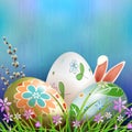 Easter composition in blue with three eggs, rabbit ears, willow branch and flowers Royalty Free Stock Photo