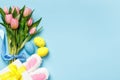 Easter composition bouquet tulips spring flowers eggs gift rabbit ears on blue background copy space Royalty Free Stock Photo