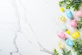 Easter composition with Bunny ears, colored eggs and green plants. Royalty Free Stock Photo