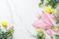 Easter composition with Bunny ears, colored eggs and green plants. Royalty Free Stock Photo