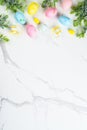Easter composition with Bunny ears, colored eggs and green plants. Royalty Free Stock Photo