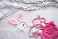 Easter composition with Easter bunny ears, medical mask, eggs and string bag top view