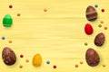 Easter composition with chocolate eggs on color wooden background, space for text. 3d render realistic vector