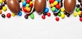 Easter composition with chocolate eggs and colorful candy, white Royalty Free Stock Photo