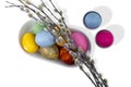 Easter composition, color eggs and spring tree branches on white, top view, close-up, place for text, flat lay and copy space