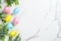 Easter composition with colored eggs and green plants on white background. Royalty Free Stock Photo