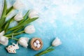 Easter composition with Easter eggs in nest and white tulips Royalty Free Stock Photo