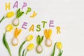Easter composition with handmade colored eggs with ears from rabbit and word Happy Easter Royalty Free Stock Photo