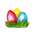 Three bright colored Easter Eggs on the spring green grass.