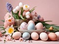 Easter composition of pastel eggs and spring bouquet with tulips, narcissus, daffodils and muscari flowers in basket Royalty Free Stock Photo