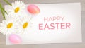 Easter composition with realistic Easter eggs, daisies on wood background Royalty Free Stock Photo