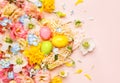 Easter composition with Spring Flowers and Easter eggs in nest on pastel pink background Royalty Free Stock Photo