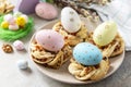 Easter composition. Sweet Italian Easter Bread Rings from puff pastry and dyed eggs on a stone background