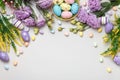 Easter composition. Top view eggs in basket purple yellow flowers on gray background Royalty Free Stock Photo