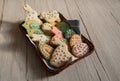 A tray of homemade cookies in the form of Easter bunnies, eggs, birds and lambs on a wooden background.