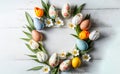 Easter composition, Wreath of painted Chocolate eggs, tulip flowers flat lay on rusted white wooden board background, spring mood Royalty Free Stock Photo