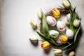 Easter composition, Wreath of painted Chocolate eggs, tulip flowers flat lay on rusted white wooden board background, spring mood Royalty Free Stock Photo