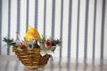 Easter composition: A yellow egg candle depicting a rabbit in a jewelry basket. Front view.