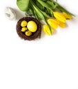 Easter composition with yellow eggs in a nest, tulips and a rabbit on a white background. Vertical orientation. Copy space, top Royalty Free Stock Photo