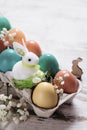 Easter concept with a bunny in nest. Painted easter eggs in egg Royalty Free Stock Photo