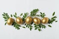 Easter concept with gold eggs and branch with green leaf on white background Royalty Free Stock Photo