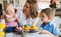 Happy and loving mother and her kids preparing home decoration Royalty Free Stock Photo