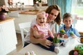 Happy and loving mother and her kids preparing home decoration Royalty Free Stock Photo