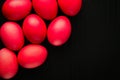 Easter concept painted eggs on black background and red for holiday with place for text red egg and paper Royalty Free Stock Photo