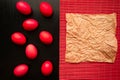 Easter concept painted eggs on black background and red for holiday with place for text red egg and paper Royalty Free Stock Photo