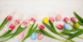 Easter concept. Pink tulips and easter eggs on white wooden background, copy space, top view, banner Royalty Free Stock Photo