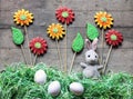 Easter concept: plush rabbit, gingerbread flower and paper grass