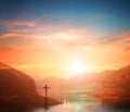 Easter concept:Silhouette cross on Calvary mountain sunset background.