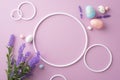 Top view photo of empty circles colorful easter eggs and bouquet of lavender flowers on isolated lilac background Royalty Free Stock Photo