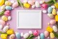 Top view photo of photo frame colorful easter eggs spring flowers yellow and pink tulips on isolated lilac background Royalty Free Stock Photo