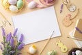 Top view photo of sketchbook brushes colorful easter eggs in bowl wooden decor ribbon chicken nest and lavender flowers