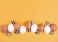 Easter concept. White and brown chicken eggs, quail eggs on a yellow background. Copy spase, top veiw Royalty Free Stock Photo