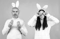 Easter couple. Funny couple wearing bunny ears and having fun with Easter eggs. Friends playing hunt eggs. Happy Easter