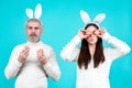 Easter couple. Funny couple wearing bunny ears and having fun with Easter eggs. Friends playing hunt eggs. Happy Easter