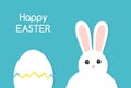 Easter cracked egg and white bunny on blue background Royalty Free Stock Photo