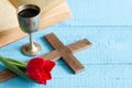 Easter cross bible and chalice tulip on blue Royalty Free Stock Photo