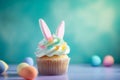 Easter cupcake with bunny ears and frosting.