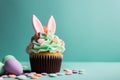 Easter cupcake with bunny ears and frosting.