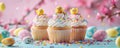 Easter cupcakes with cream, decorated with chickens and sprinkles on pink background and colorful eggs. Easter greeting Royalty Free Stock Photo
