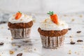 Easter Cupcakes Or Muffins With Cream And Carrot Candy On Light Marble Background. Holiday Cake Celebration, Delicious Dessert,