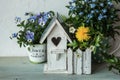 Easter decor with bird house and spring flowers Royalty Free Stock Photo