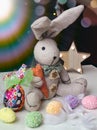 Easter decor, toy bunny with colored eggs and a burning star Royalty Free Stock Photo