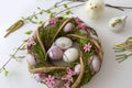 Easter decorated wreath, hen and faucet with easter eggs as decoration. Photo on white background