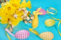 Easter decoration with bunch of daffodil and rabbit figurine Royalty Free Stock Photo